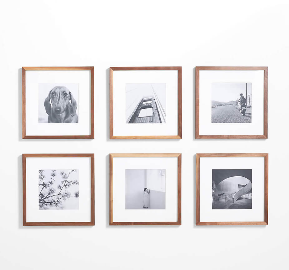 Six photos with wood frames hanging on a wall